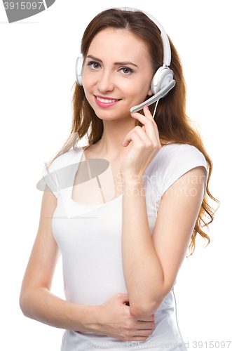 Image of Lovely young woman is talking to customers