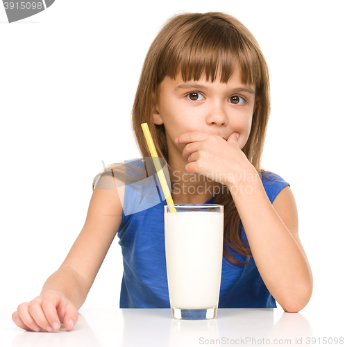 Image of Cute little girl with a glass of milk