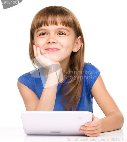 Image of Young girl is using tablet