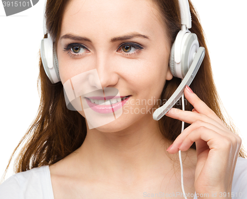 Image of Lovely young woman is talking to customers