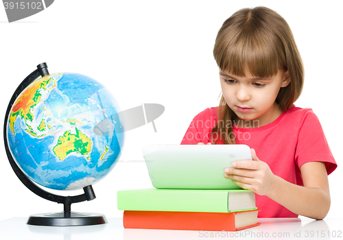 Image of Young girl is using tablet