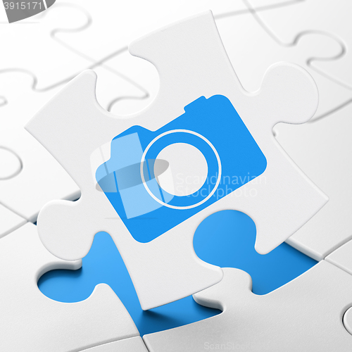 Image of Tourism concept: Photo Camera on puzzle background