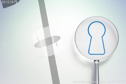 Image of Data concept:  Keyhole with optical glass on digital background