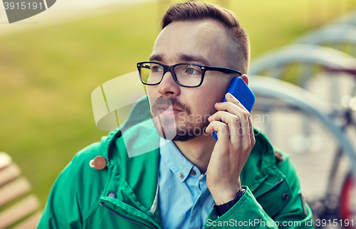 Image of young hipster man calling on smartphone