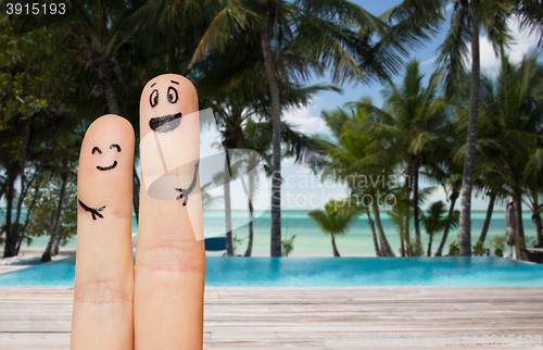 Image of close up of two fingers with smiley faces