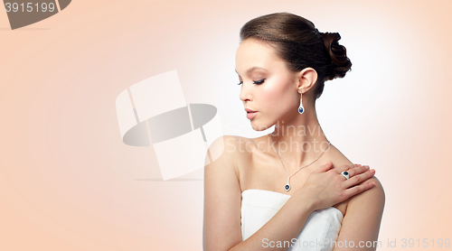 Image of beautiful woman with earring, ring and pendant