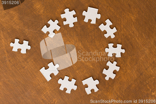 Image of close up of puzzle pieces on wooden surface