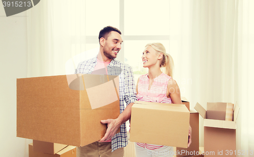 Image of couple with big cardboard boxes moving to new home