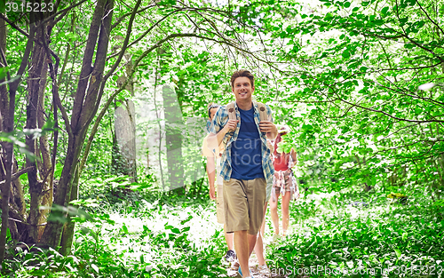 Image of group of smiling friends with backpacks hiking