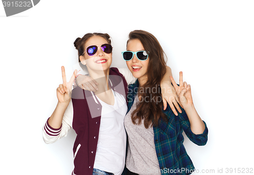 Image of smiling teenage girls in sunglasses showing peace