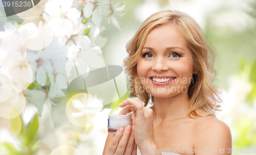 Image of happy woman with cream jar