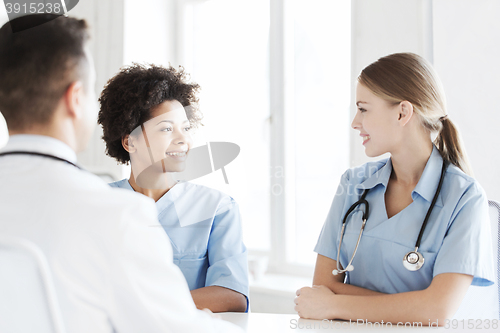 Image of group of happy doctors meeting at hospital office