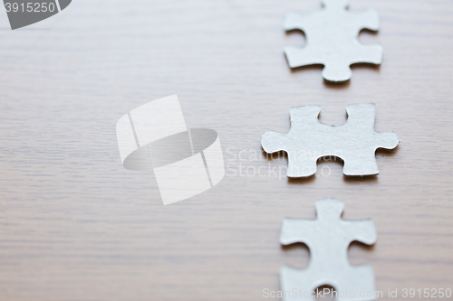 Image of close up of puzzle pieces on wooden surface