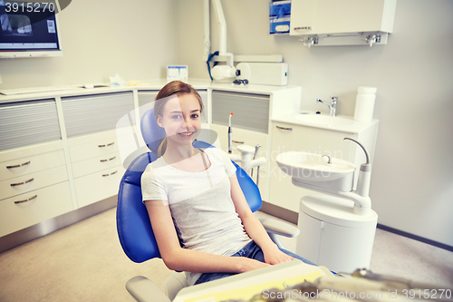 Image of happy patient girl at dental clinic office