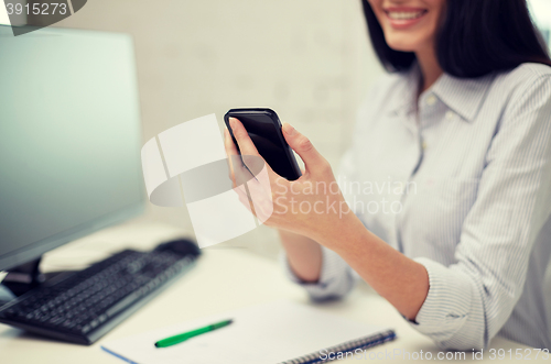 Image of close up of woman texting on smartphone at office