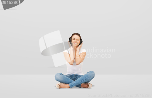 Image of smiling young woman or teen girl in headphones