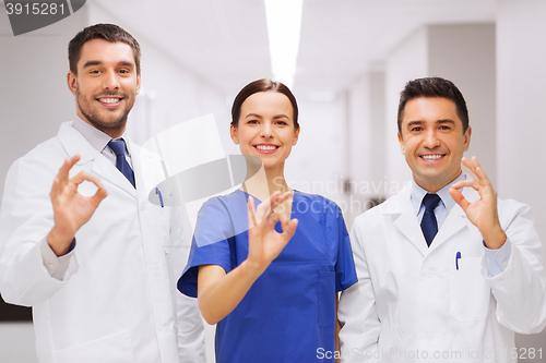 Image of group of medics at hospital showing ok hand sign