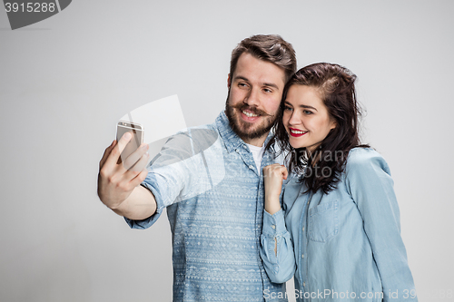 Image of Portrait of happy couple on gray background