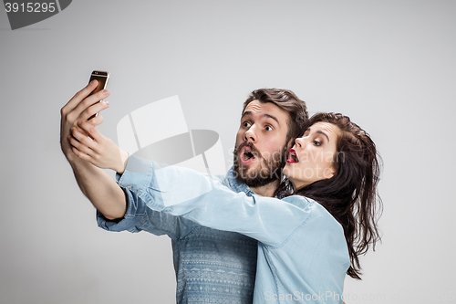 Image of Portrait of happy couple on gray background