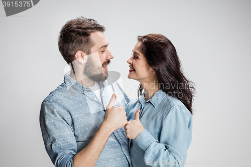 Image of Two young smiling people with thumbs-up gesture