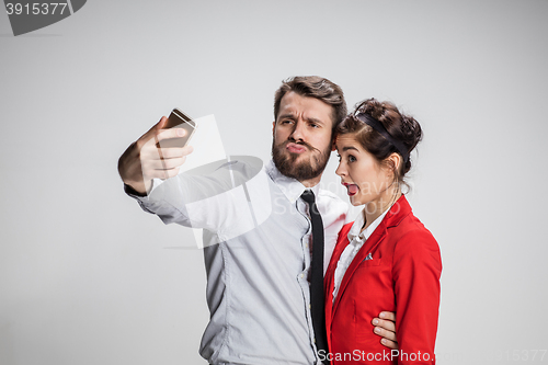 Image of Two colleagues friends taking selfie with telephone camera