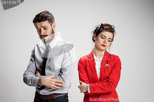 Image of The sad business man and woman conflicting on a gray background