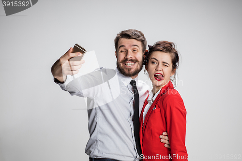 Image of Two colleagues friends taking selfie with telephone camera