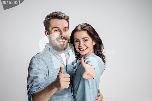 Image of Two young smiling people with thumbs-up gesture