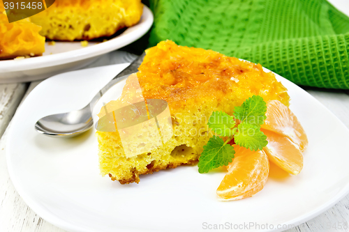 Image of Pie mandarin with mint and spoon on light board