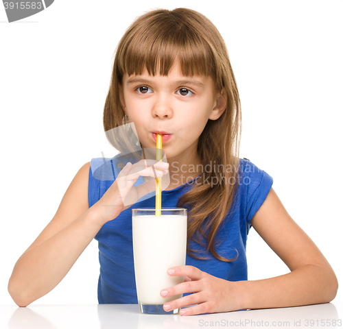 Image of Cute little girl with a glass of milk