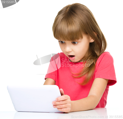 Image of Young girl is using tablet