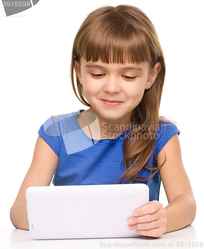 Image of Young cheerful girl is using tablet