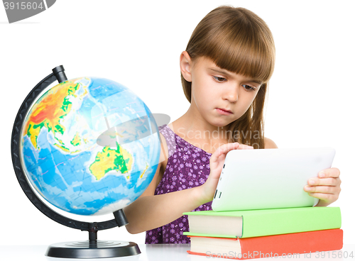 Image of Young girl is using tablet