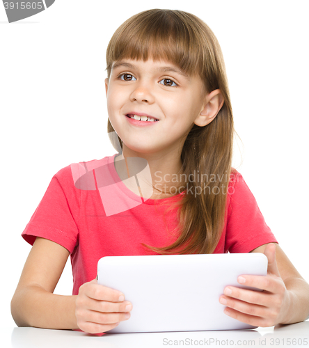 Image of Young girl is using tablet