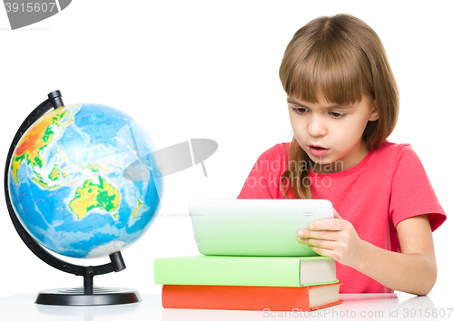 Image of Young girl is using tablet