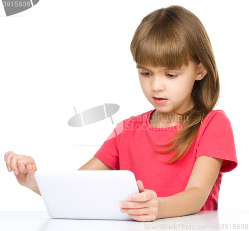 Image of Young girl is using tablet