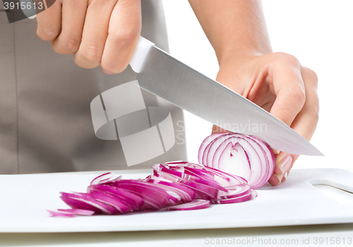 Image of Cook is chopping onion