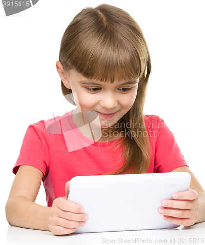 Image of Young girl is using tablet