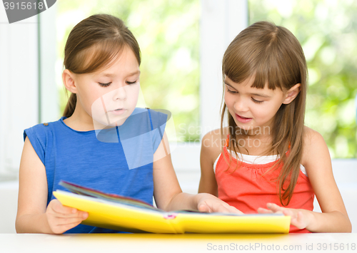 Image of Little girls are reading book