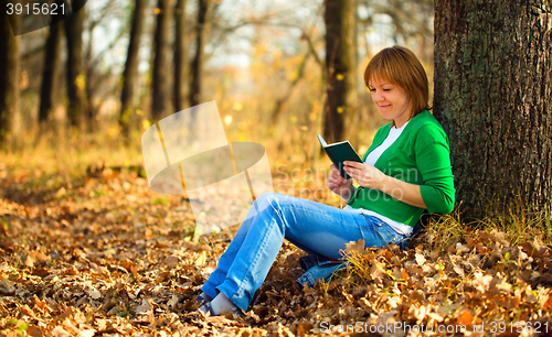 Image of Portrait of a woman in autumn park