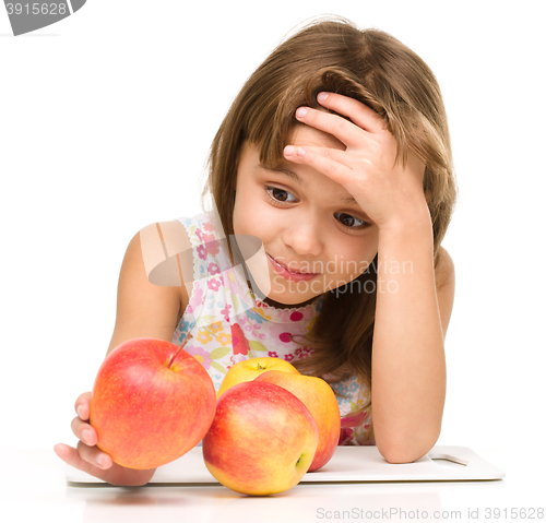 Image of Little girl with red apples