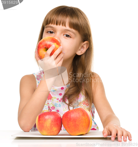 Image of Little girl with red apples