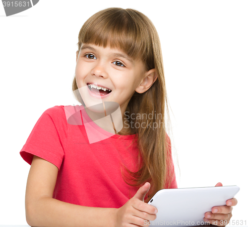 Image of Young girl is using tablet