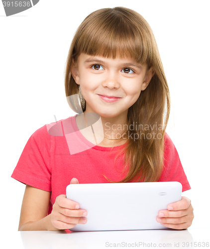 Image of Young girl is using tablet