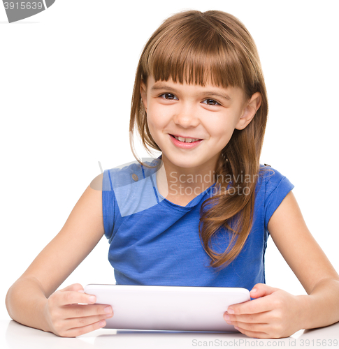 Image of Young cheerful girl is using tablet
