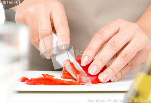 Image of Cook is chopping bell pepper