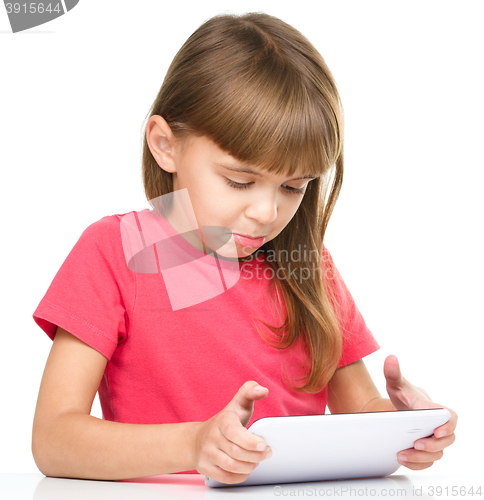 Image of Young girl is using tablet