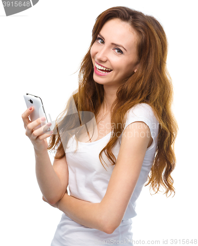 Image of Young woman is pleased by incoming message