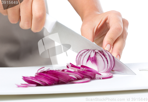 Image of Cook is chopping onion