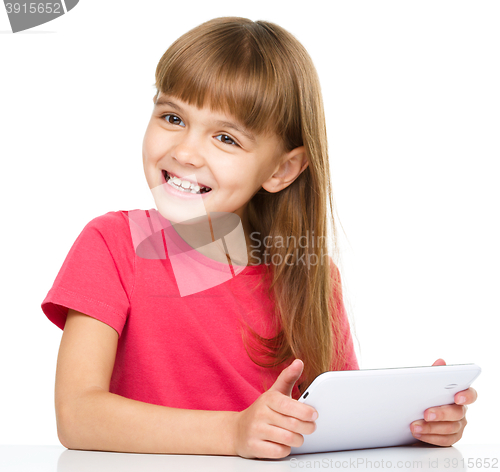 Image of Young girl is using tablet